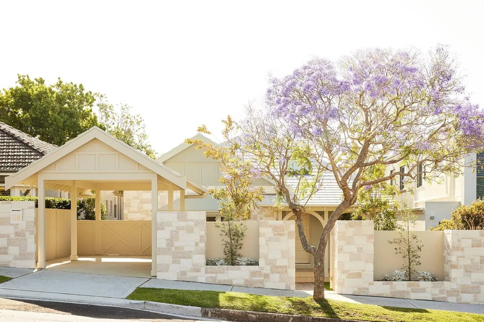 Refreshed Californian Bungalow street frontage after renovation, with pale stonework and a landscaped garden