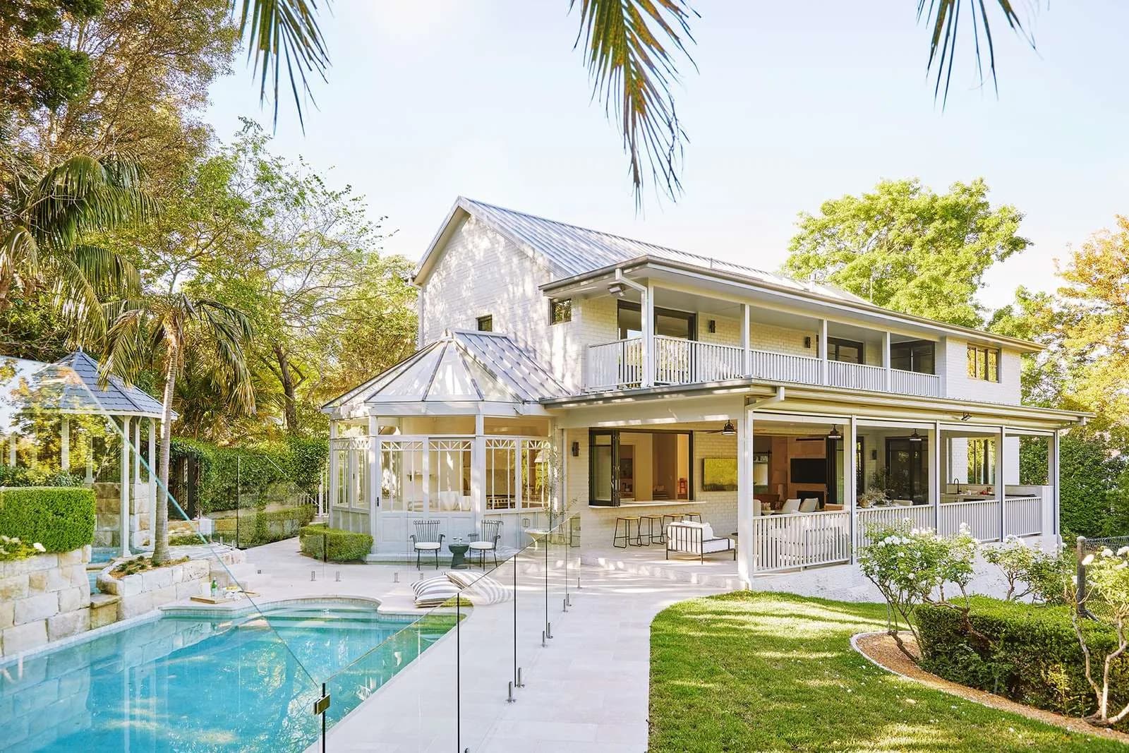Rear of a home showing the pool, garden and a large covered alfresco verandah